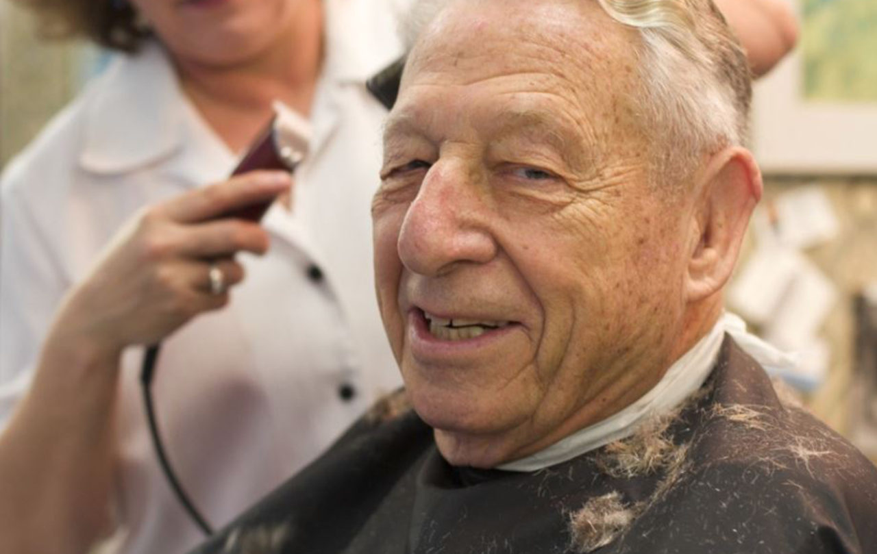 A senior participant enjoying an activity at a SarahCare adult day health center
