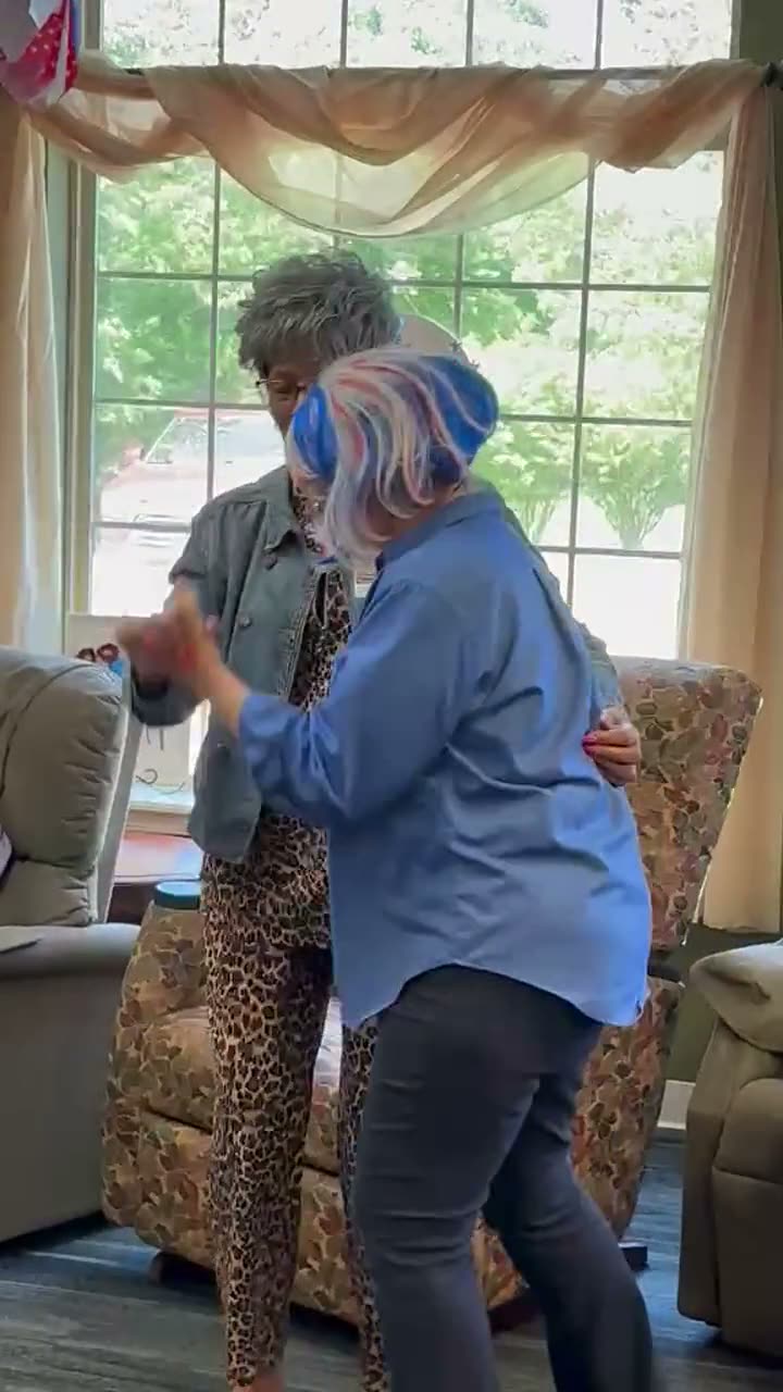 Staff member dancing with a participant