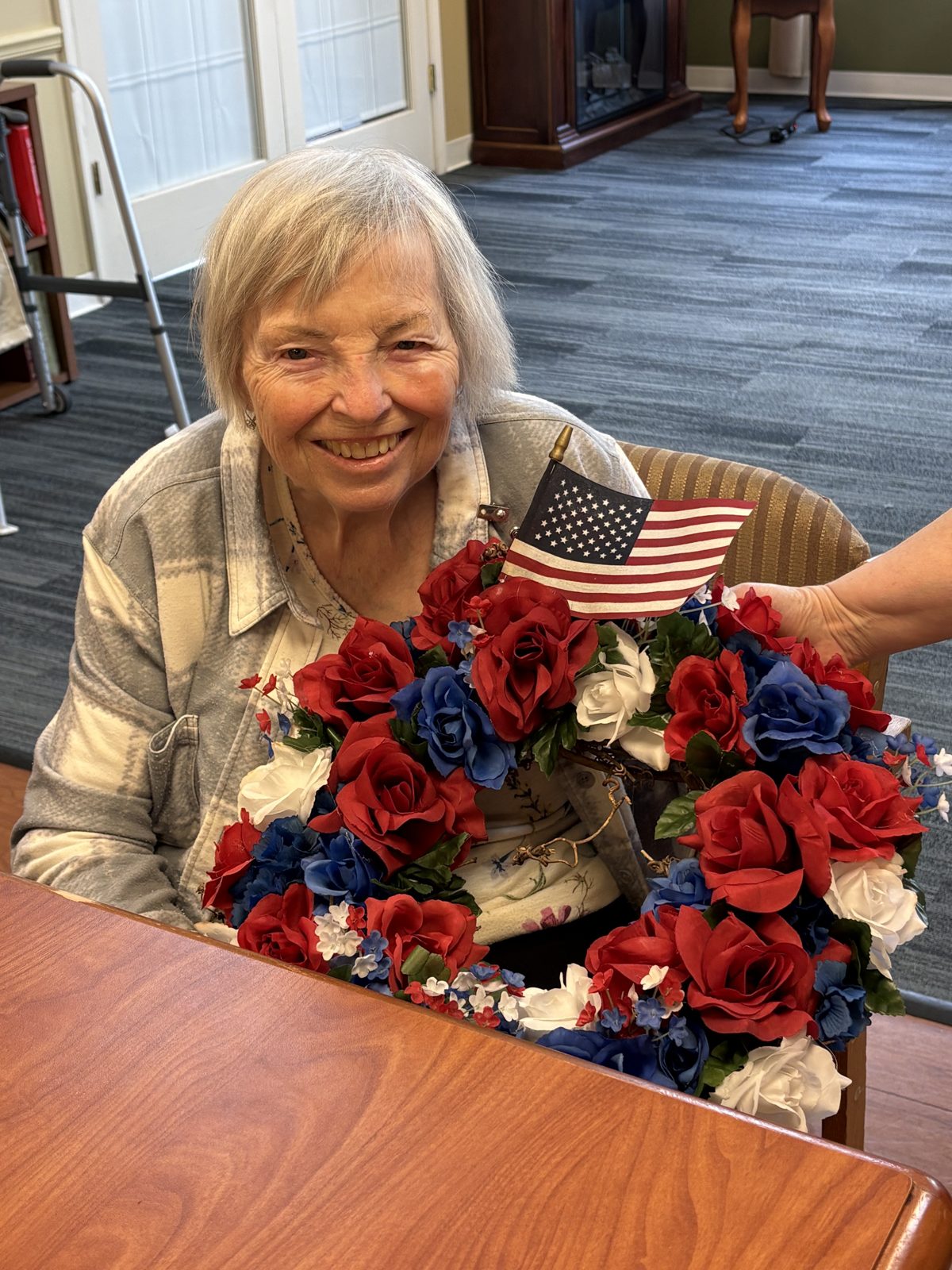Participant with a red, white, and blue floral centerpiece