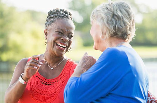 Two senior friends smiling together
